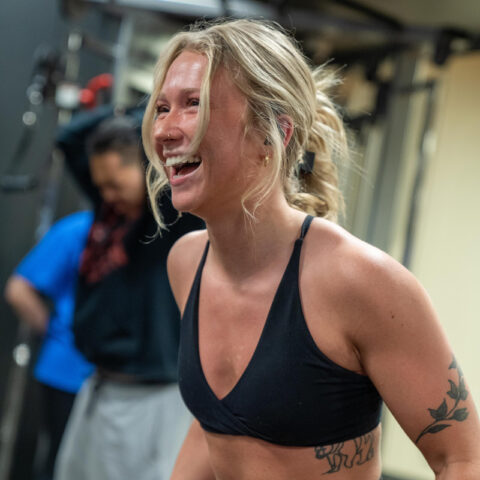 Young woman exercising arms at the gym