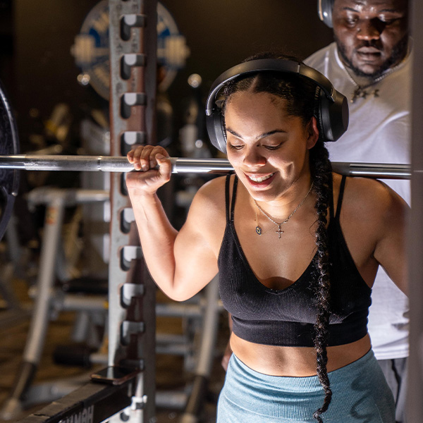 Woman doing squats at the gym